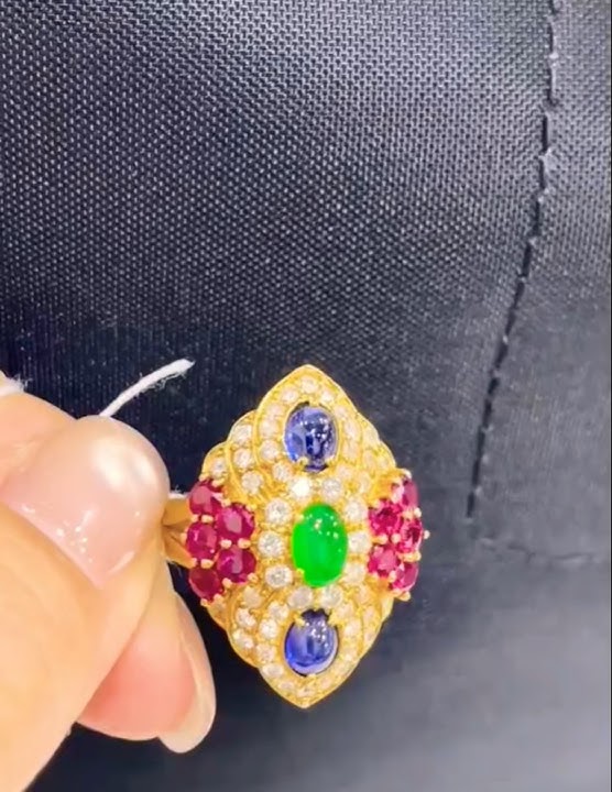 A colorful ring with ruby, sapphire, and emerald, surrounded by diamonds #gemsnjewellery #gemstone