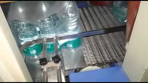SEMI AUTOMATIC SHRINK WRAPPING MACHINE FOR MINERAL WATER PACKING.