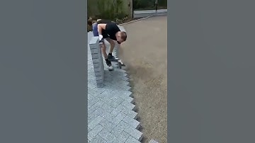 The man was very skilled at installing paving blocks in his yard using high-quality stones.#popular