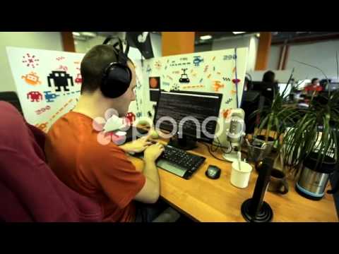 Funny programmer In Headphones Sitting At The Computer | Stock Footage Video