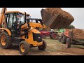 JCB 3DX Loading Sand to a Tactor