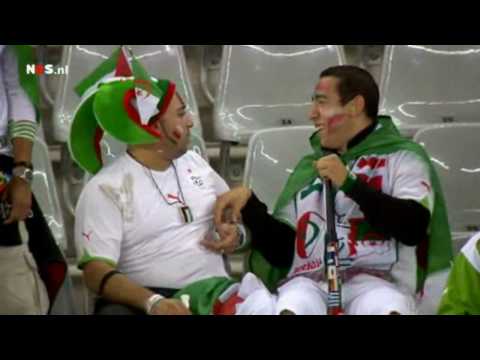 Algerian fan blows in friends ear with a Vuvuzela [2010 World Cup]