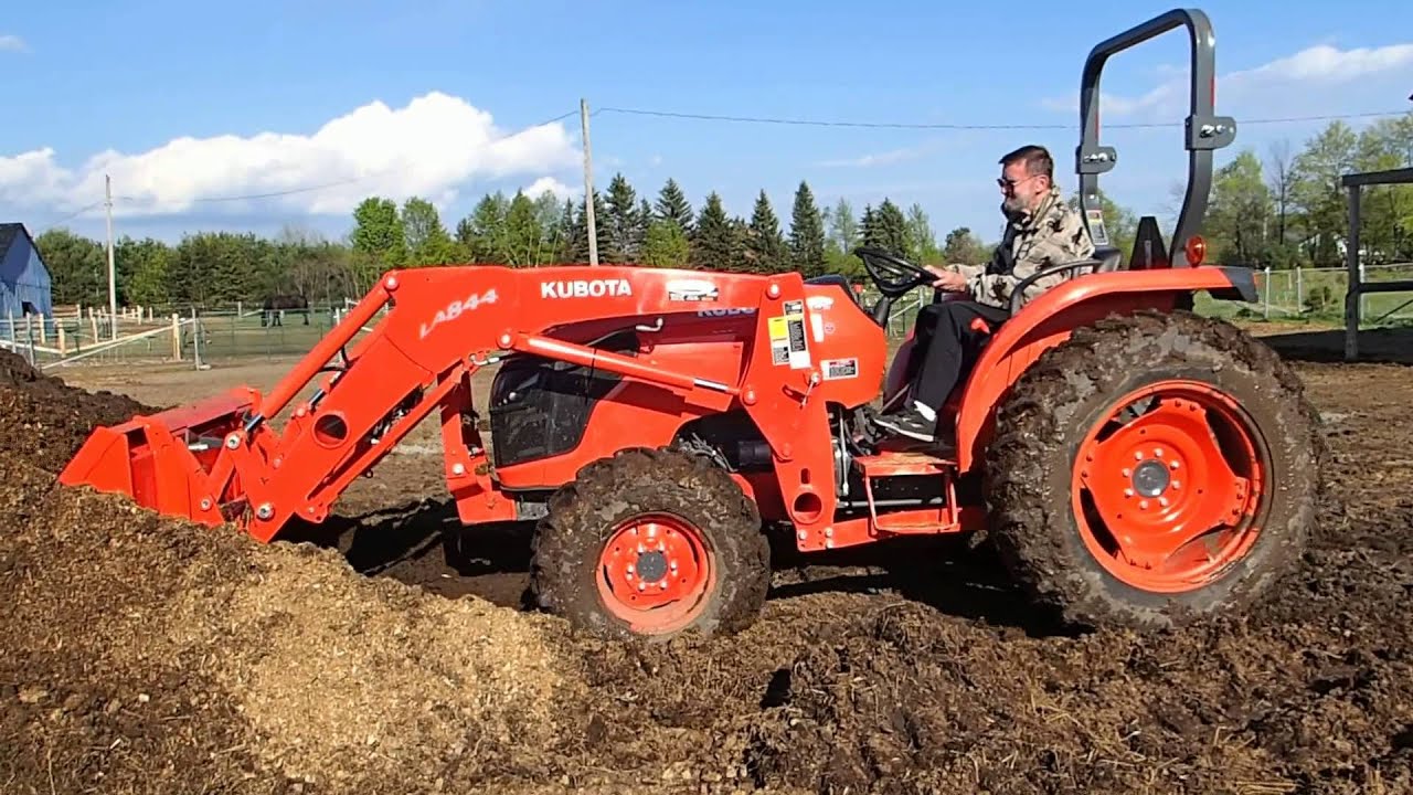 Dad using the front-end loader on the Kubota MX5100 tractor (his first time!) ...