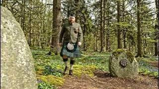Scotsman Walking Wearing Kilt By Standard Stone On Spring History Visit To West Fife Scotland