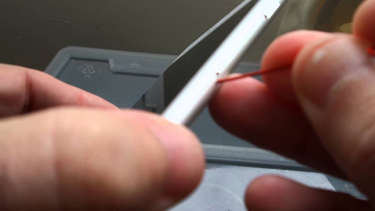 Open iPhone SIM tray with a paperclip