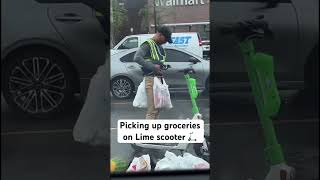 Man Picks Up Groceries On Lime Scooter