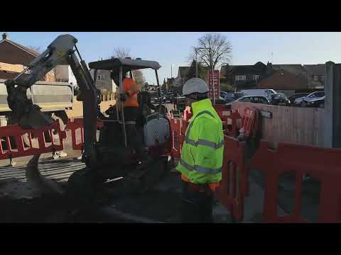 severn trent workmen dig a hole / digger action and grab action