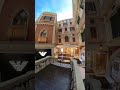 A gondola passes under a canal bridge in the venetian macao