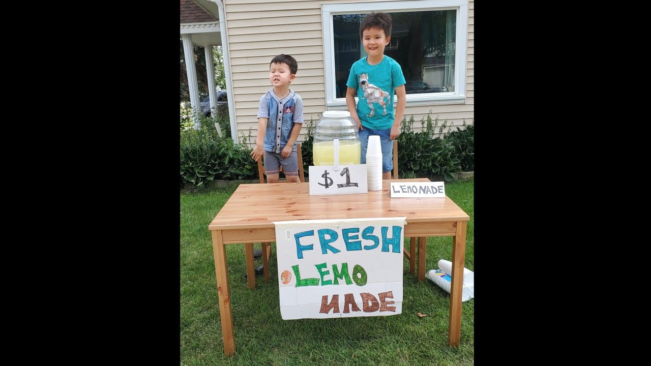 7 year old boy earns money by selling lemonade