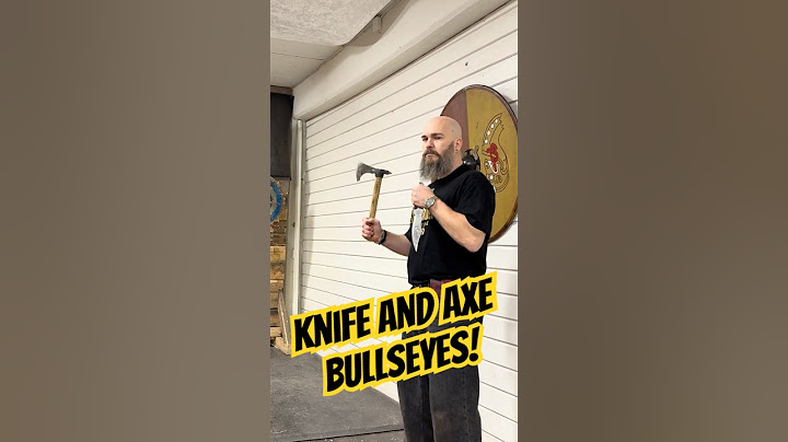 World champion thrower does a fast draw knife throwing next to an axe for two perfect bullseyes