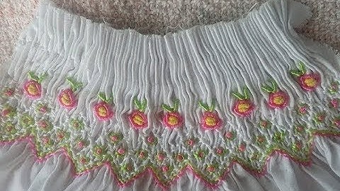 Smocking embroidery with Roses using Bullion stitch on the chest of a dress