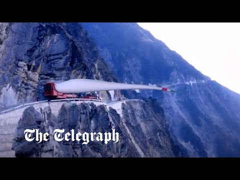 Moment wind turbine blade is carried up steep mountain slope in China