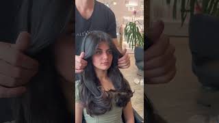 Layered hair cut with long curtain bangs