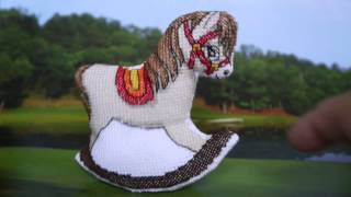 Hand embroidered toy.