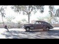 Corey busboom pulling a 1941 pontiac from two hooks pierced in the back