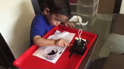 My toddler painting with black