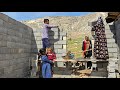 Nomadic familys efforts to complete the wall and expand the house