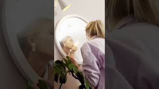Woman Applying Lipstick In Mirror