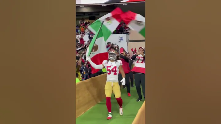 Fred Warner leads the 49ers onto the field with th...
