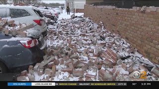 Brick Wall Crumbles Onto Cars During Strong Wind And Snow