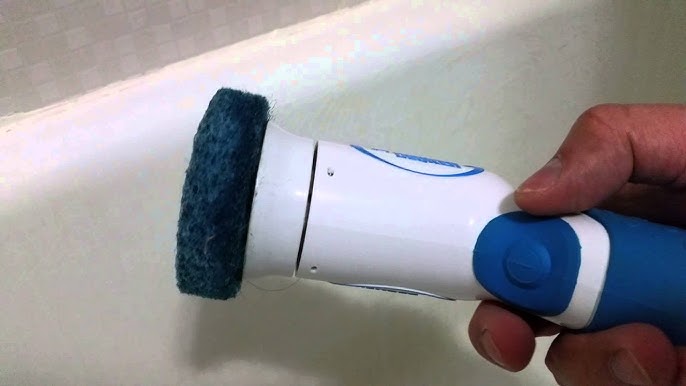 Doug washes dishes with a power scrubber