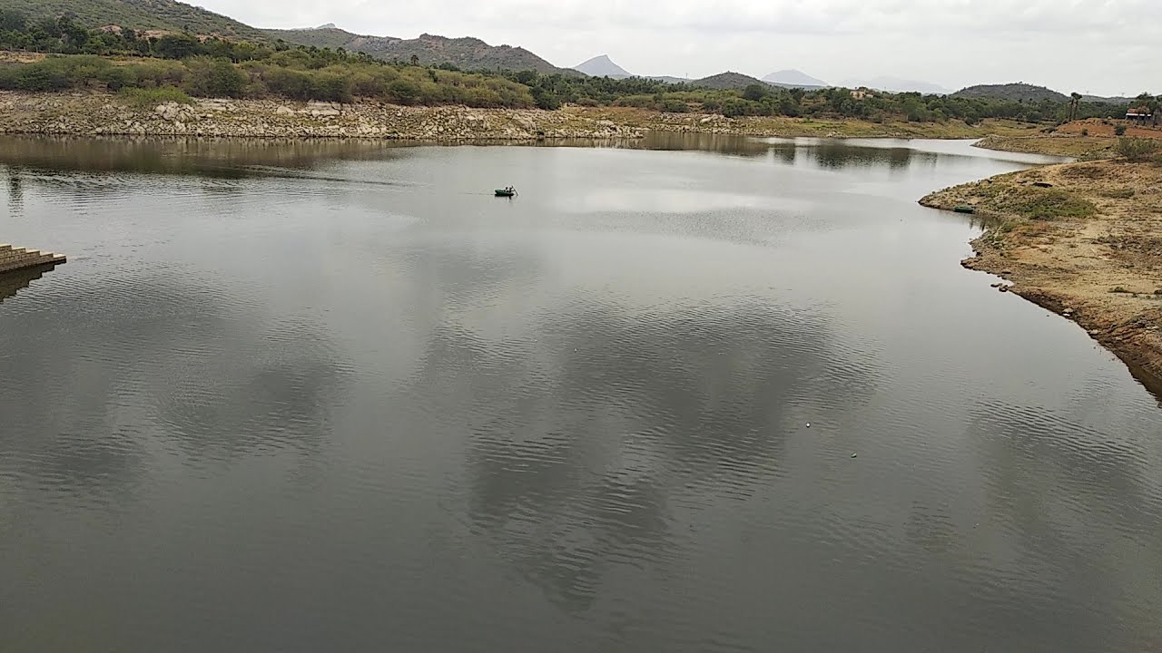 Fisherman in boat at a beautiful Dam in rural India | Very calm and natural scenery