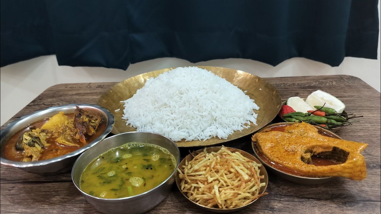 Bhapa ilish, murighonto, daal, jhuri alu bhaja with king chilli