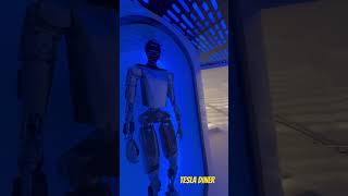 Inside the Tesla diner …. See Optimus in the middle of stairs #tesla #optimus #tesladiner