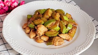 Delicious quick dinner! Tender chicken fillet with zucchini in a frying pan.