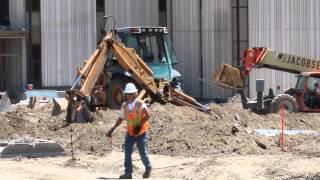 Case Backhoe getting set up to work and digging with back excavator arm