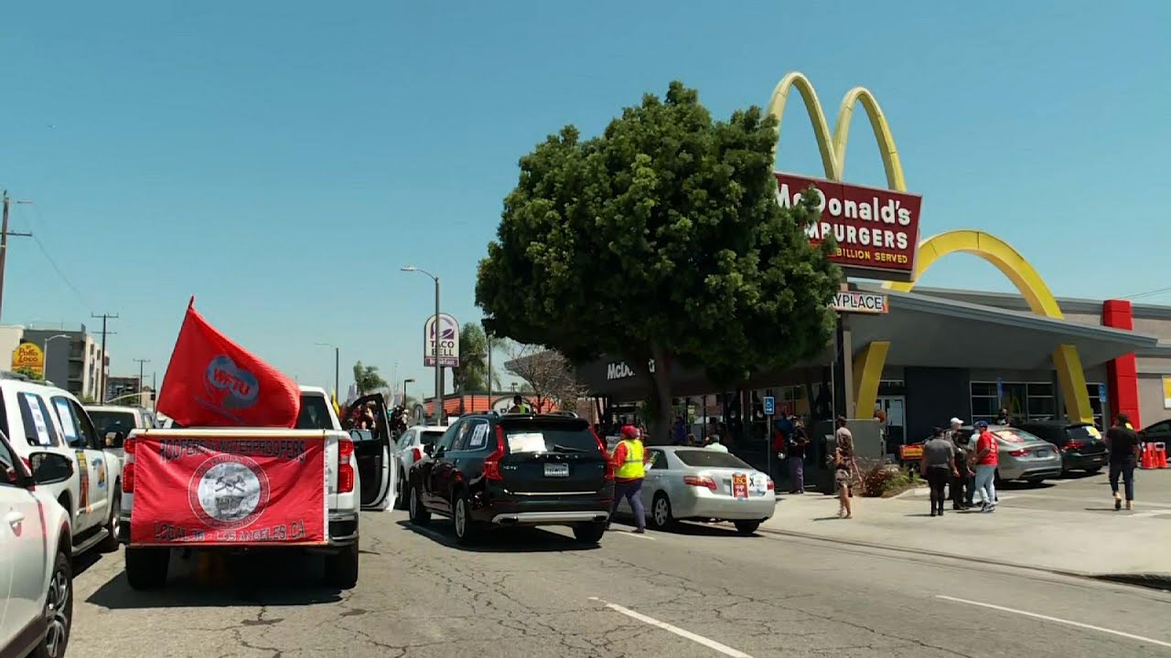 Cars block Los Angeles street, protest inequality