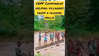 CRPF Commandos helping villagers cross after a nalla flooded due to heavy rain in Chhattisgarh