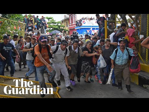 Migrant caravan in Guatemala breaks through border fence into Mexico