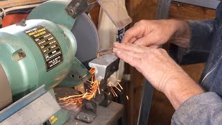 Richard Raffan shapes and sharpens two new gouges, preparing them for use.