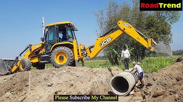 JCB Backhoe installing culvert pipe in drain.