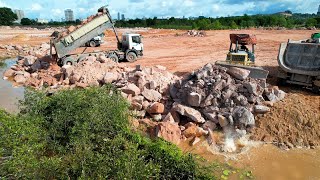 Skillful Heavy Equipment Operator Bulldozer Pushing Rock Stone Drop Into Water For Land Reclamation