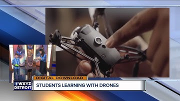 Students learning to code with drones