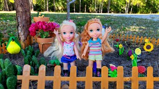 Gardening ! Elsa & Anna toddlers plant flowers outdoors