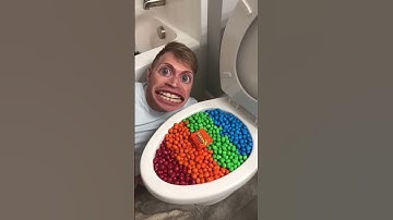 Thumbnail of Eating Colorful Chocolate M&M's Candy in Toilet