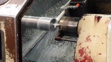 Mazak turning S.S. using tailstock in auto mode. C.N.C. lathe turning and threading.
