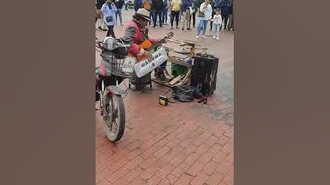 Artist Plays Multiple Musical Instruments on Street - 1497601