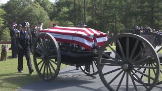 Jumper's casket arrives at gravesite on horse-drawn carriage