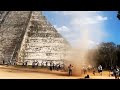 Man runs through dust devil at foot of Mayan pyramid in Chichén Itzá