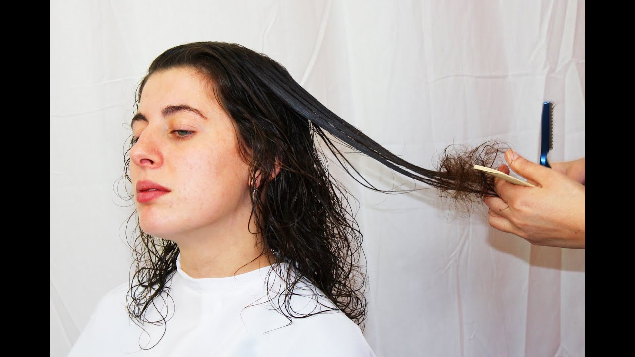 Sweet girl with curled hair getting an haircut and a straight style