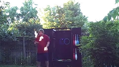 Juggling 3 Flaming Tennis Balls On A Rola Bola Balance Board