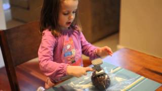 Ava cracking open her Chocolate Easter Egg Wealth