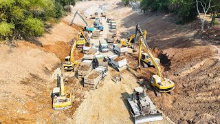 Great action Dump truck unloading rock soil building foundation Canal dozer pushing, excavator digg