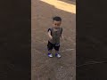 Baby boy walking a lone at temple