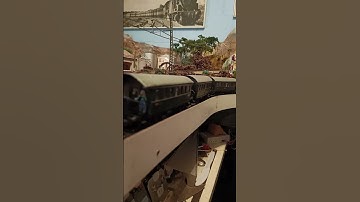 Marklin analog DB 4-6-4 passenger train going out of tunnel exit from station