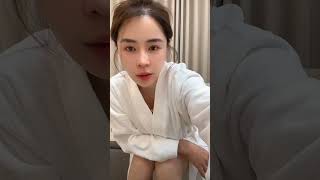 Details Highlights from a beauty's livestream: A young woman in a pristine white bathrobe chats casually ... News
